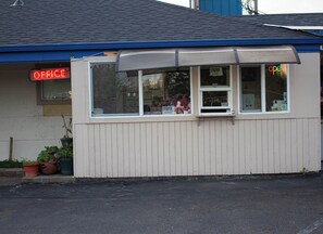 A small building with a sign that reads 'OFFICE' in red neon lights.
