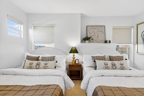 A room with two beds, a nightstand with a lamp, and artwork on the walls. - Unique Downtown LA Gem: World Cup, SoFi, Gym & Games - 2 suites (Los Angeles)