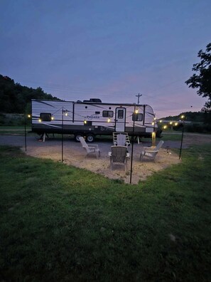 A Pioneer RV with a covered outdoor seating area and string lights. - Creekside Family camping near Clearwater Lake! (Piedmont)
