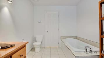 A bathroom with a toilet, a sink, and a bathtub.