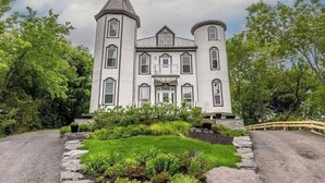 A large, historic building with a symmetrical facade, multiple windows, and a central entrance.