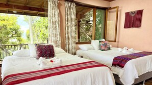 Two beds with white linens, a red and white striped blanket, and a wooden ceiling. - Apartment # 1 Chi-ya, San Juan laguna (San Juan la laguna)