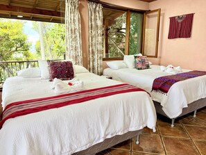 Two beds with white linens, a red and white striped blanket, and a wooden ceiling. - Apartment # 1 Chi-ya, San Juan laguna (San Juan la laguna)