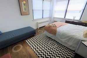 A bedroom with a bed, a sofa, a radiator, a window, and a desk. - 2-bedroom apartment in a wonderful Philadelphia neighborhood with AC (Philadelphia)