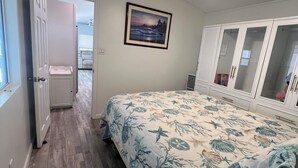 A bedroom with a bed, a ceiling fan, a framed picture, and a wardrobe. - Relaxing 2 Bedroom with Panoramic Lake View from inside and out (Lake Havasu City)