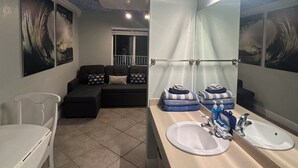 A bathroom with two sinks, a mirror, and a ceiling with a textured pattern. - COSTAL GETAWAY ON CLEARWATER BEACH (Clearwater)