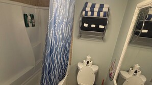A bathroom with a shower, toilet, and a towel rack. - COSTAL GETAWAY ON CLEARWATER BEACH (Clearwater)