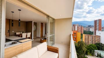 A modern apartment with a balcony, a dining area, and a kitchen.