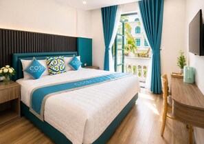 A hotel room with a bed, a desk, and a view of the outside. - Cosi Beach Hotel Phu Quoc - Sunset (Phu Quoc)