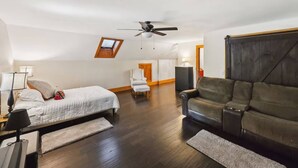 A bedroom with a bed, a ceiling fan, a desk, a chair, a couch, and a wooden wardrobe. - Walk to Cushing Academy ! Sleeps 10 (Ashburnham)