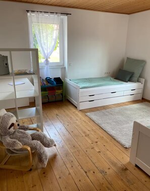 A child's bedroom with a bunk bed, a desk, a chair, and a window with curtains. - Vrbo Property (Lohr am Main)