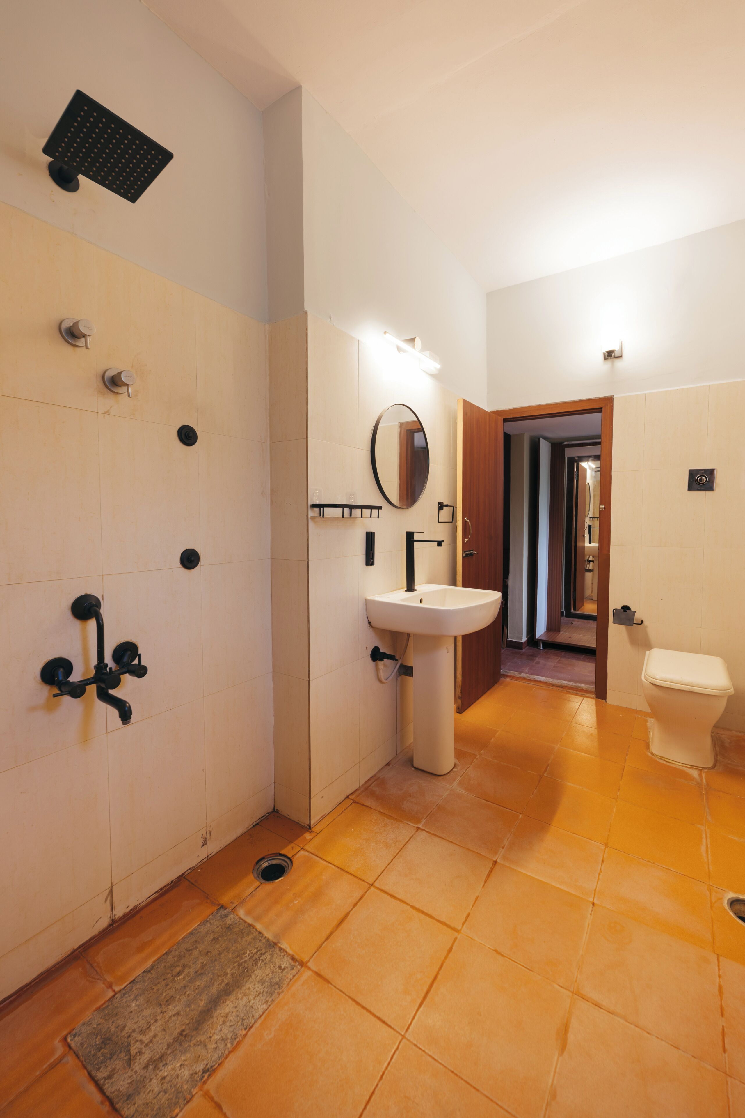 A bathroom with a shower, sink, and toilet.