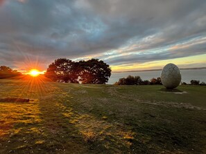 A grassy field with a large spherical sculpture and a sunset in the background. - Open special price / Shodoshima Island in the Seto Inland Sea / Shikai with a view of the beauty of many islands / Rental of a building / Grand piano / Tea ceremony room / Welcome drink / Pick-up service at ports and sightseeing spots on request / Free fe (小豆郡土庄町伊喜末)