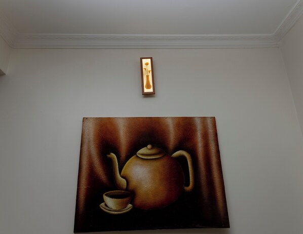 A painting of a teapot and cup on a wall. - La Licorne Apartments . Serene 2BR in Kicukiro . Short term & long term Rentals (Kigali)