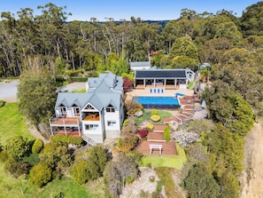 A two-story house with a swimming pool, outdoor seating, and a garden. - Mount View Estate - A Luxury Getaway with Unforgettable Views (Yarra Junction)
