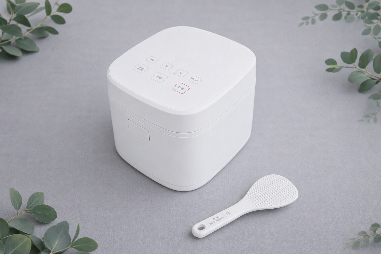 A white appliance with a control panel and a spatula.