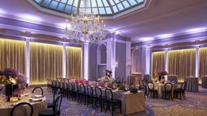 A banquet hall with a high ceiling, chandeliers, and draped curtains. - 4th of July Weekend for America's 250th Anniversary at Historic Mayflower Hotel (Washington)