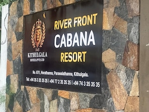 A sign for River Front Cabana Resort, including the hotel's name, address, and contact numbers. - Kithulgala Cabana Resort (Kithulgala)