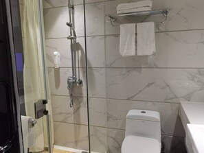 A bathroom with a shower, toilet, and a towel rack. - Chengyue International Hotel (Guangzhou)