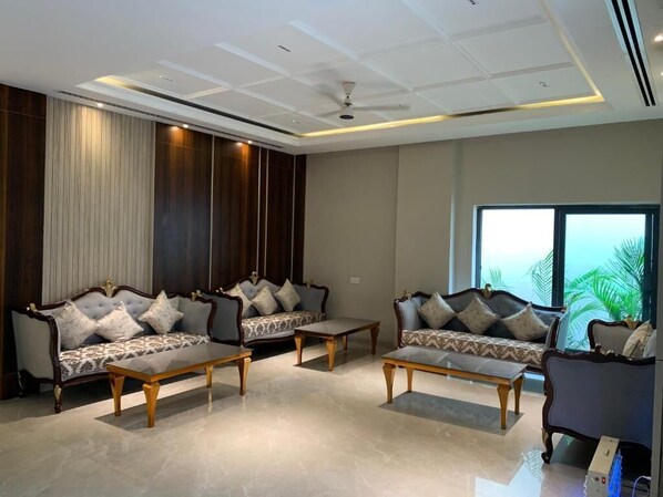 A modern living room with two sofas, a coffee table, and a large window with a view.