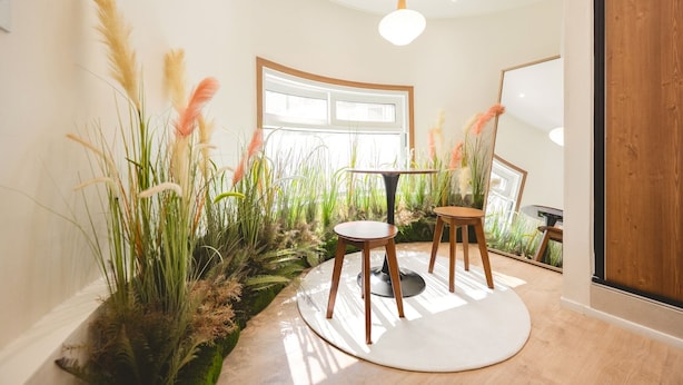 A room with a round table, two chairs, a large window, and a staircase. - Stay Log in Sinchon Hongdae (Seoul)