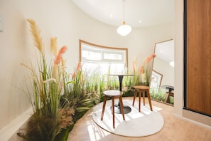 A room with a round table, two chairs, a large window, and a staircase. - Stay Log in Sinchon Hongdae (Seoul)