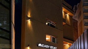 A building with the sign 'EASY STAY' indicating a hotel. - Stay Log in Sinchon Hongdae (Seoul)