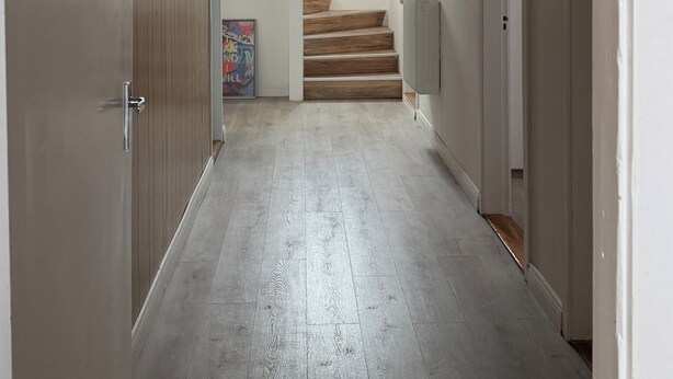 A hallway with a wooden staircase, white walls, and a ceiling light. - Ocean view in delightful Borgarnes with cool views and environment (Borgarnes)