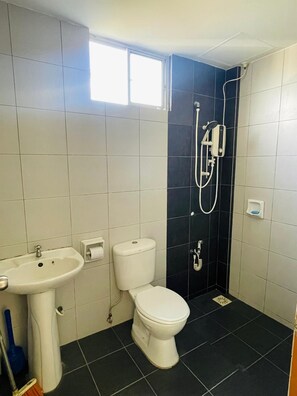 A bathroom with a toilet, sink, and shower. - Oak & Ivory Home • Cozy Clean 3BR • 5km to Airport (Kota Samarahan)