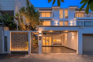 Uma casa moderna de dois andares, com garagem coberta e acesso coberto.