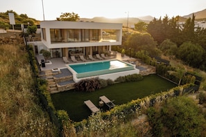 A modern two-story house with a swimming pool, outdoor seating, and a well-maintained garden. - Villa Castaño sea views with heated Pool | Estepona | 8p (Estepona)