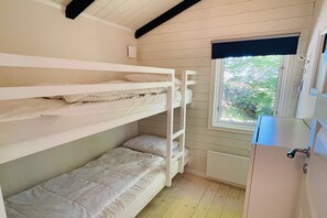A bunk bed room with a window, a radiator, and a cabinet. - 4 star holiday home in KARLSHAMN (KARLSHAMN)