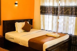 A bed with a wooden headboard, white bedding, and a brown throw blanket. - Heavens Gate Ella (Ella)