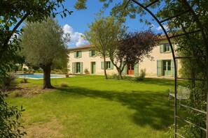 A two-story building with a swimming pool, green shutters, and a well-maintained lawn. - At Domaine du Pape (Mazères)