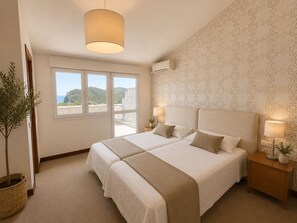 A double bed with a headboard, bedside lamps, a potted plant, and a view of the outdoors through a window. - Hotel Arresi (Lemoiz)