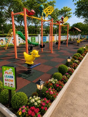 A playground with swings, slides, and a duck-shaped seesaw.