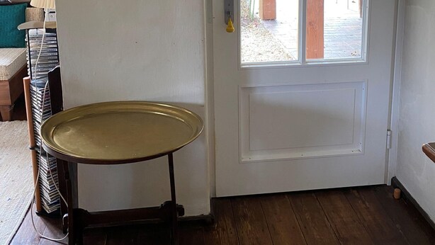A room with a white door, a small table, a mirror, and a window. - Nusshof Vacation Home for up to 9 people (Berchtesgaden)