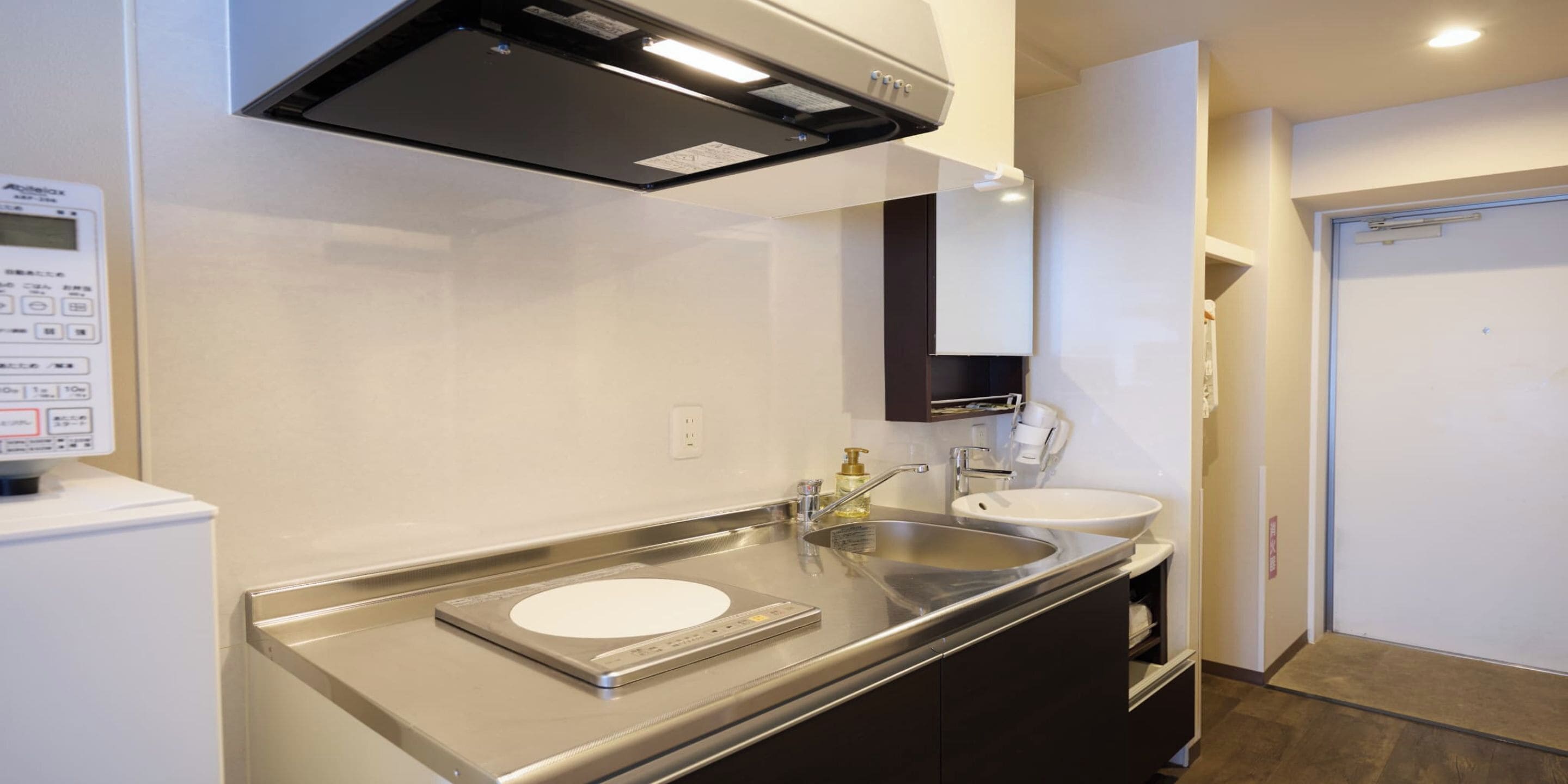 A modern kitchen with stainless steel appliances, a built-in oven, and a double sink.