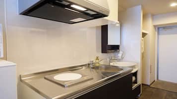 A modern kitchen with stainless steel appliances, a built-in oven, and a double sink.