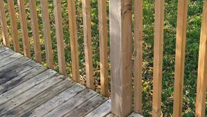 A wooden deck with a railing, surrounded by grass and a wooden fence. - Modern 3-Bedroom Retreat Near Moncton Hospital and Downtown (Moncton)