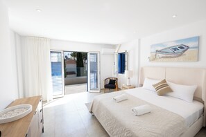 A hotel room with a bed, a chair, a desk, and a painting on the wall. - Luxury 3 bedroom villa, 100 meters from Protaras Marina (Paralimni)