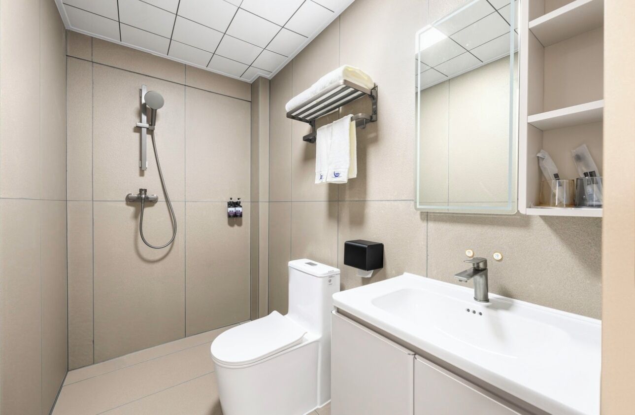 Shower, hair dryer, slippers, towels
