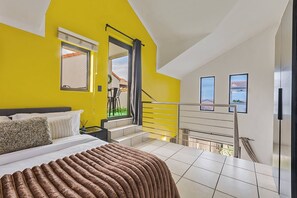 A bedroom with a bed, a window, a staircase, and a view of the outside. - Zalari Luxe Loft A, Spacious 2-Bed Loft, Paulshof (Sandton)