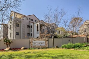 A modern building with a sign reading 'THE MATRIX' in front. - Zalari Loft B, Nature-Inspired 2 Bed Loft Paulshof (Sandton)