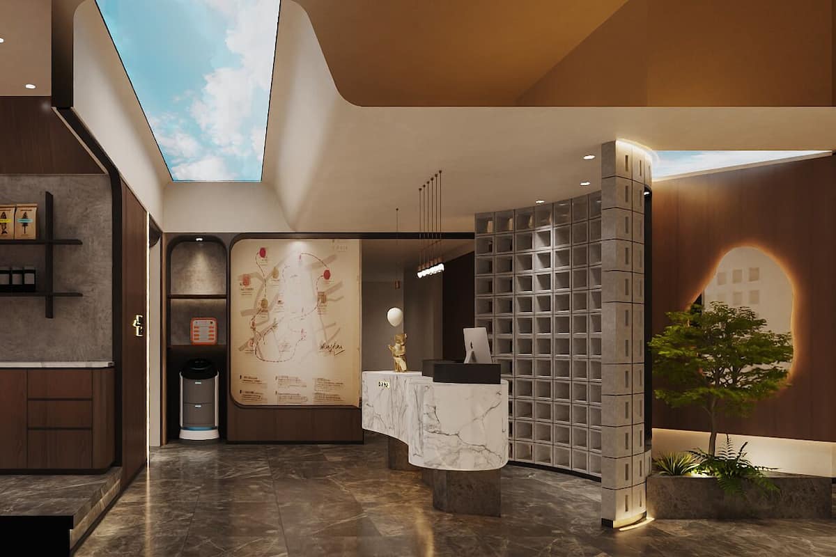 A modern hotel lobby with a reception desk, a coffee machine, a map on the wall, and a plant.