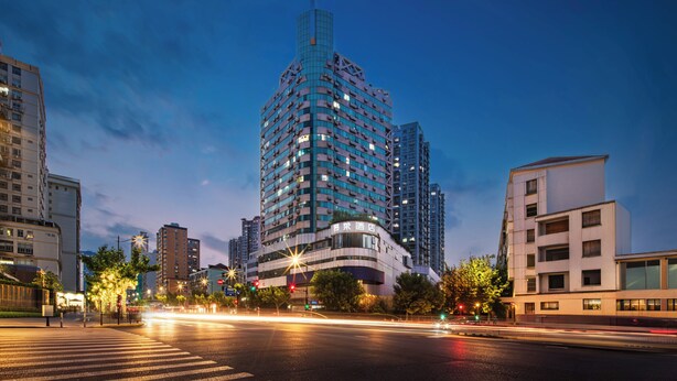 A modern high-rise hotel with a distinctive curved facade, multiple balconies, and a prominent entrance. - Jinglai Hotel Shanghai Yuyuan Xintiandi Lujiabang Road Metro (Shanghai)