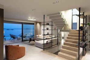 A modern interior with a staircase, a sofa, and a view of the ocean. - Villa K&J. (Mlini)