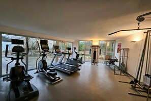 Ett gym med löpband, crosstrainers och styrketräningsutrustning.