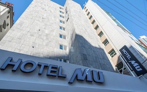 A modern building with a prominent 'HOTEL MU' sign. - MU Plus Hotel Busan (Busan)