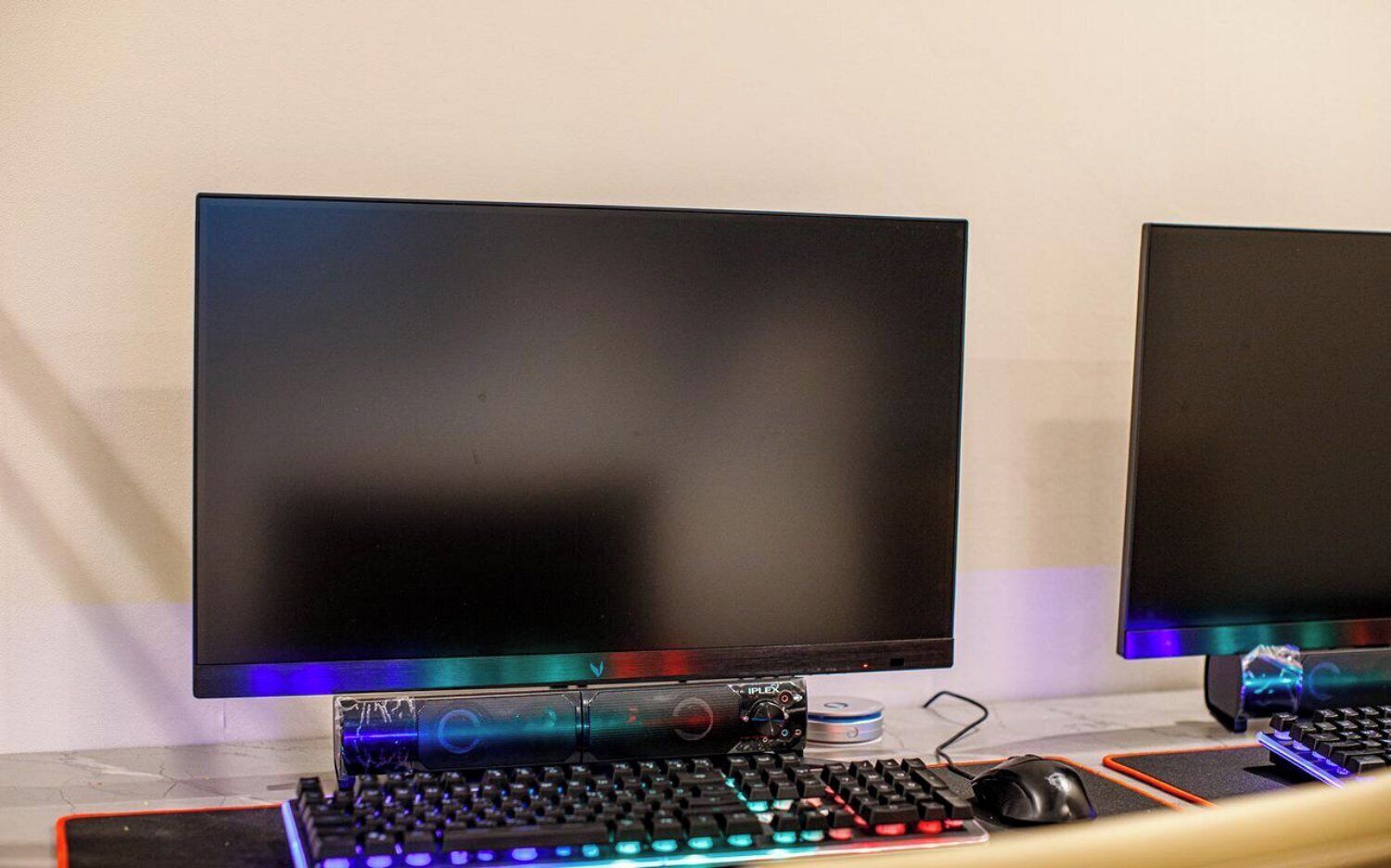 Two monitors, a keyboard, and a mouse on a desk.